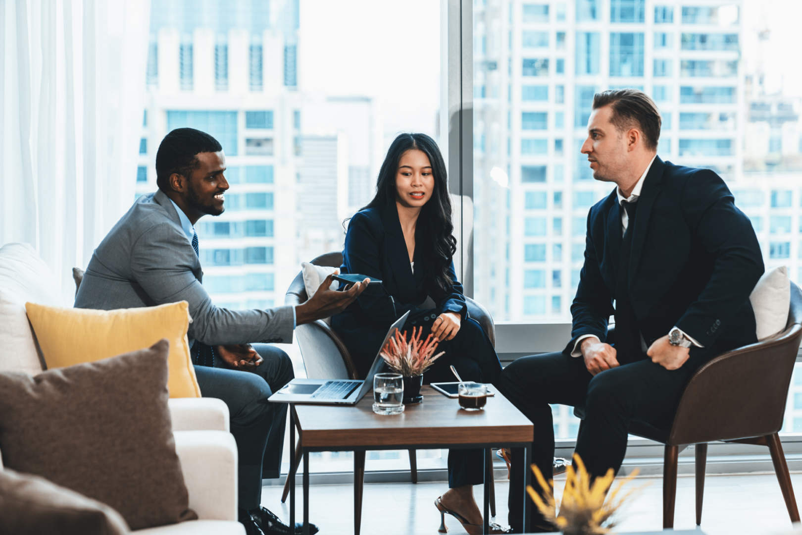 Business meeting with three professionals in office.