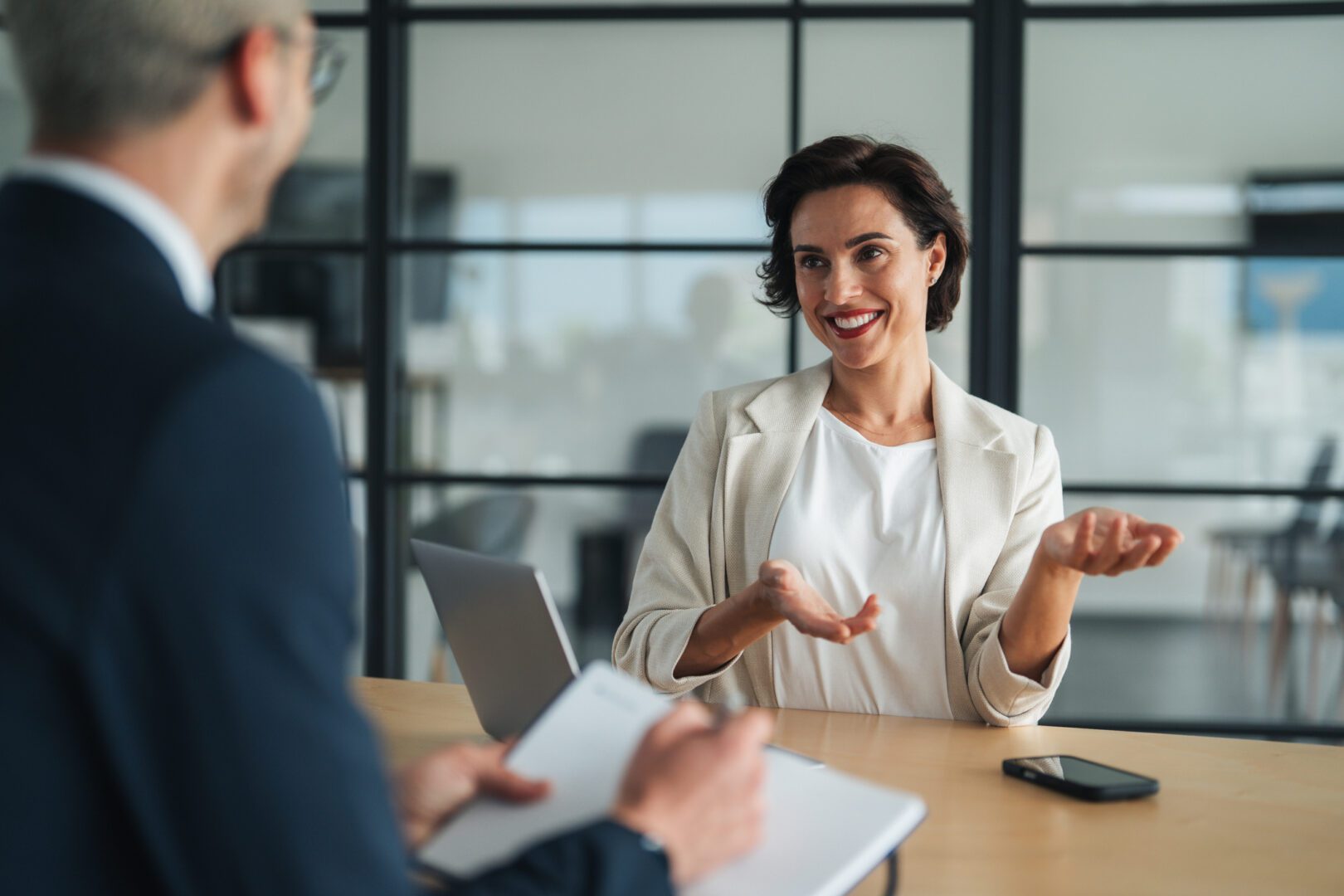 Woman smiling during a business meeting.