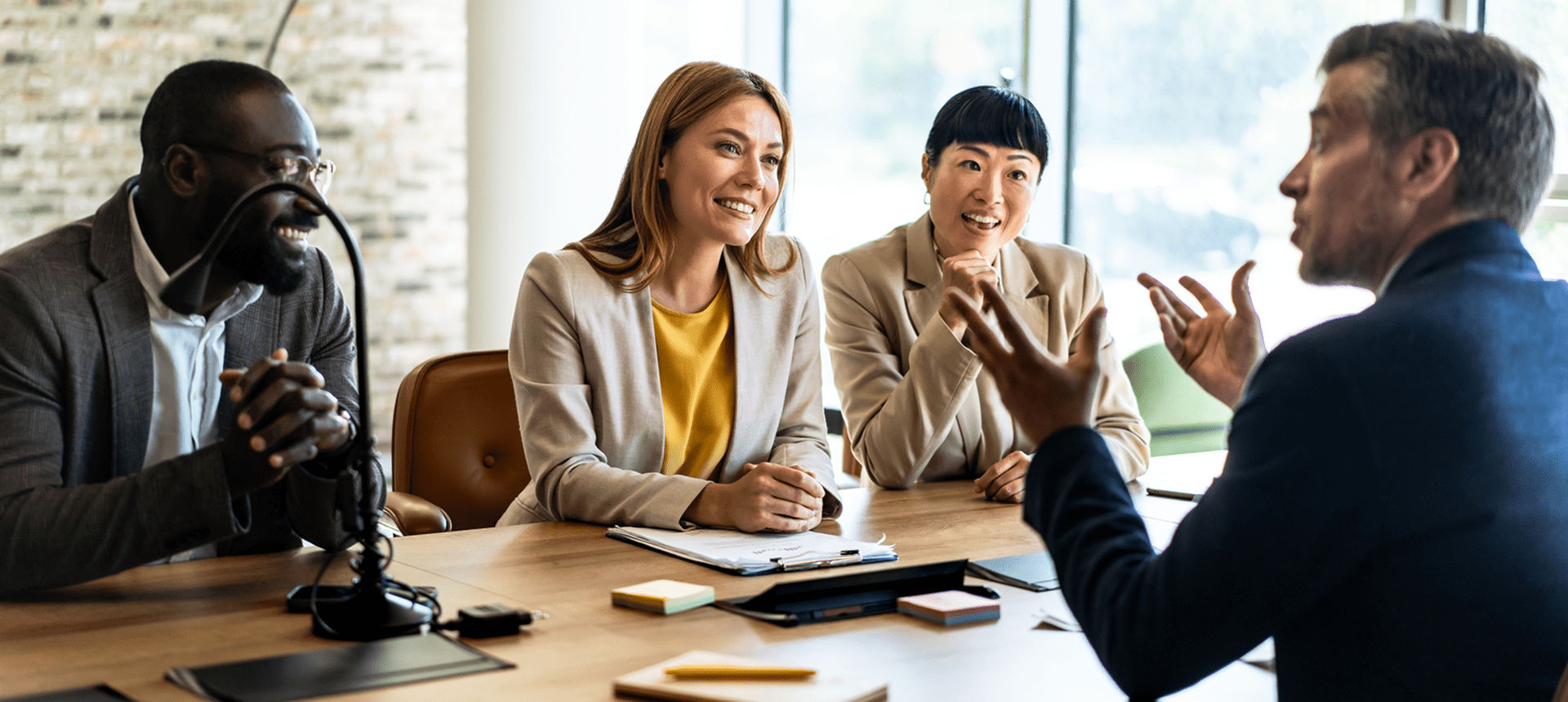 Business meeting with four people discussing.