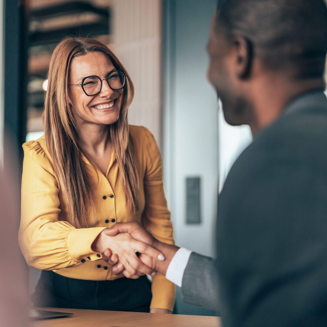 Professional handshake between colleagues in office.